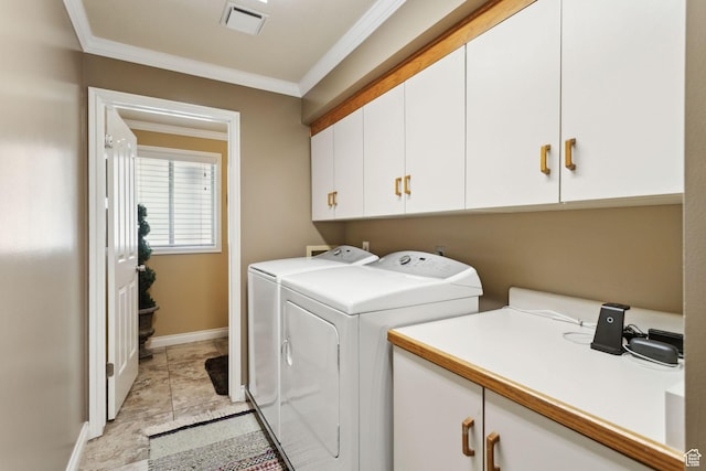 washroom with cabinet space, washing machine and clothes dryer, crown molding, and baseboards