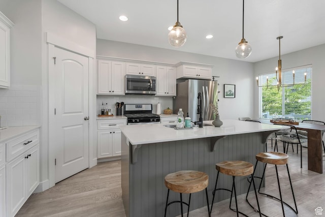 15378 S Skyraider Ln, Bluffdale, UT 84065 - kitchen featuring stainless steel appliances, light wood finished floors, white cabinetry, and recessed lighting