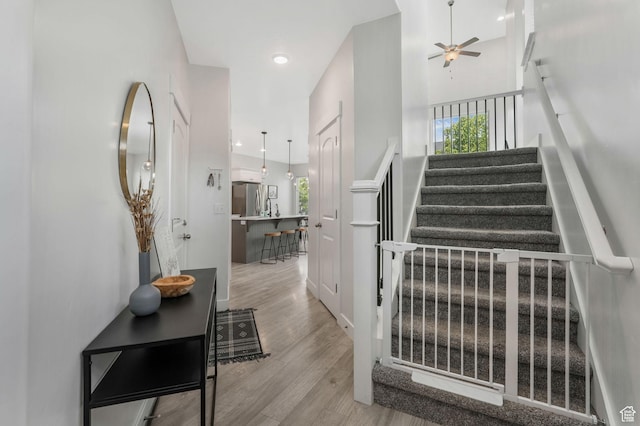 15378 S Skyraider Ln, Bluffdale, UT 84065 - stairs featuring wood finished floors, a ceiling fan, plenty of natural light, and recessed lighting