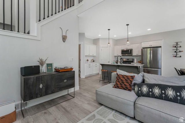 15378 S Skyraider Ln, Bluffdale, UT 84065 - living room featuring light wood finished floors and recessed lighting