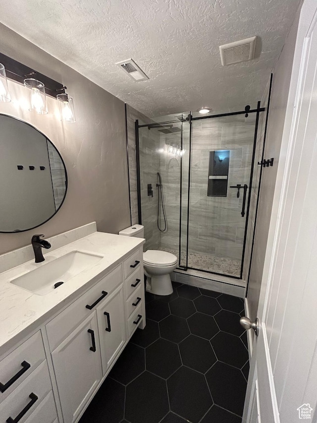 642 W 1250 S, Lehi, UT 84043 - bathroom featuring vanity, a stall shower, toilet, a textured ceiling, and tile patterned floors