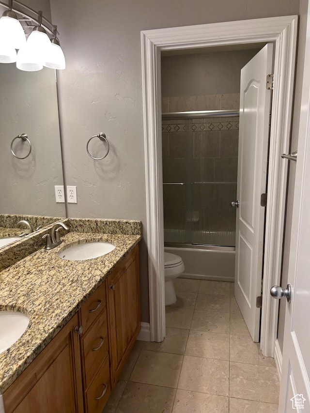 642 W 1250 S, Lehi, UT 84043 - bathroom featuring toilet, double vanity, tile patterned floors, and bath / shower combo with glass door