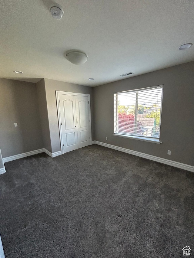 642 W 1250 S, Lehi, UT 84043 - unfurnished bedroom with baseboards, dark colored carpet, and a closet