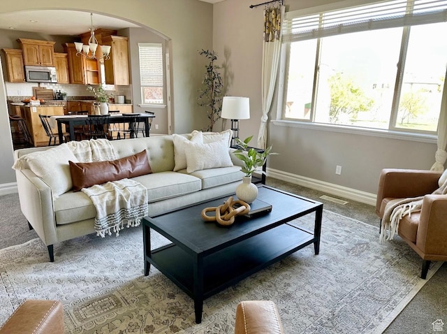 642 W 1250 S, Lehi, UT 84043 - living room with a chandelier, light carpet, baseboards, and arched walkways