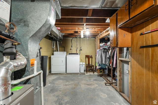 unfinished basement featuring washing machine and clothes dryer