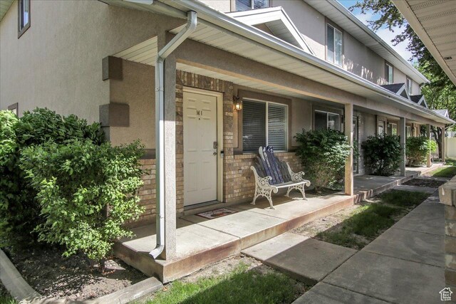 2421 N 400 E Unit M-1, North Ogden, UT 84414 - property entrance with covered porch and stucco siding