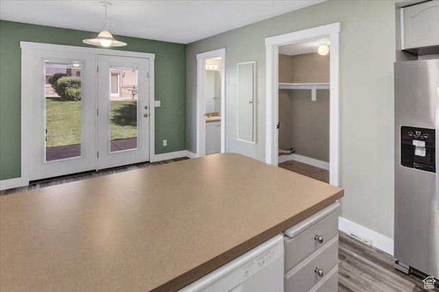 2421 N 400 E Unit M-1, North Ogden, UT 84414 - kitchen with stainless steel fridge with ice dispenser, white cabinetry, baseboards, hanging light fixtures, and wood finished floors