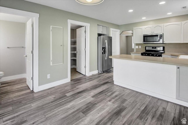 2421 N 400 E Unit M-1, North Ogden, UT 84414 - kitchen featuring stainless steel appliances, white cabinets, wood finished floors, and recessed lighting