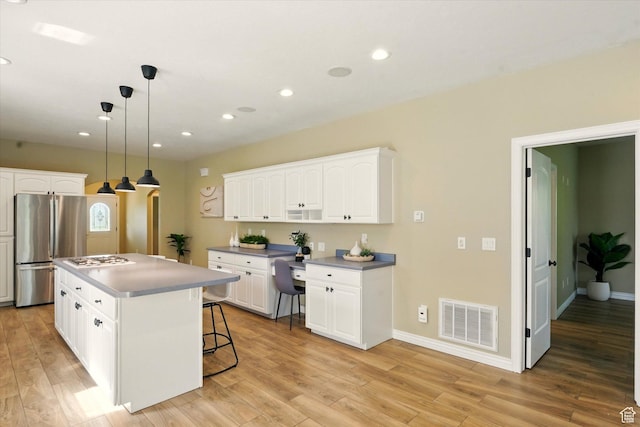2897 W 3400 N, Benson, UT 84335 - kitchen featuring freestanding refrigerator, light wood-type flooring, white cabinetry, a center island, and recessed lighting