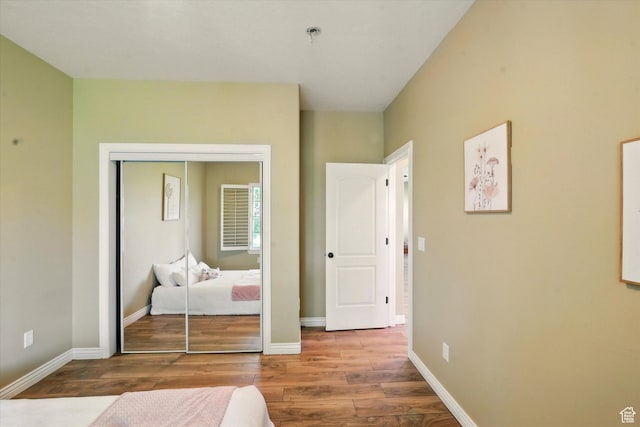 2897 W 3400 N, Benson, UT 84335 - bedroom with wood finished floors, a closet, and baseboards