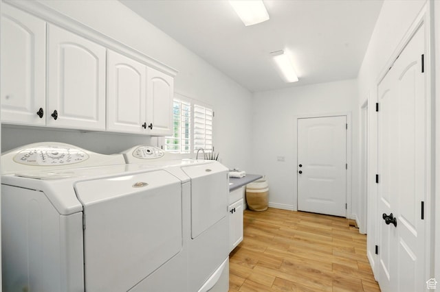 2897 W 3400 N, Benson, UT 84335 - clothes washing area featuring cabinet space, separate washer and dryer, and light wood finished floors