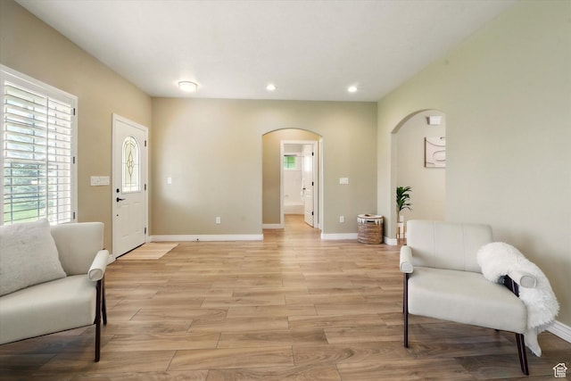 2897 W 3400 N, Benson, UT 84335 - living area featuring arched walkways, recessed lighting, baseboards, and light wood-style floors