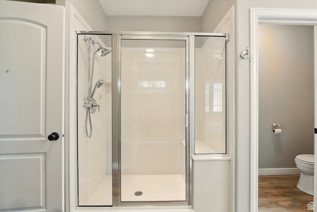 2897 W 3400 N, Benson, UT 84335 - bathroom with a shower stall, wood finished floors, toilet, and baseboards