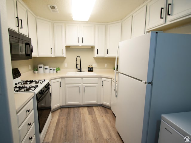 1456 S 430 W, Orem, UT 84058 - kitchen with gas stove, freestanding refrigerator, black microwave, a sink, and light wood-type flooring