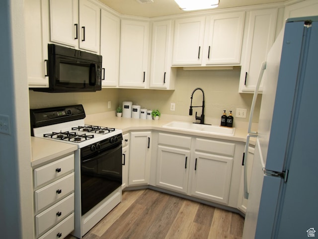 1456 S 430 W, Orem, UT 84058 - kitchen with black microwave, freestanding refrigerator, gas stove, a sink, and white cabinetry