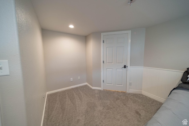 unfurnished bedroom with carpet floors and baseboards