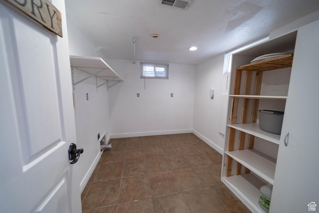 clothes washing area with baseboards and recessed lighting