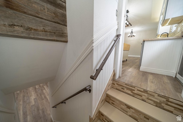 stairway featuring wood finished floors