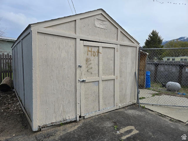 view of shed featuring fence
