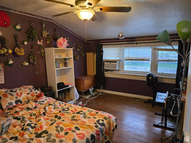 bedroom featuring wood-type flooring, a textured ceiling, cooling unit, baseboards, and vaulted ceiling