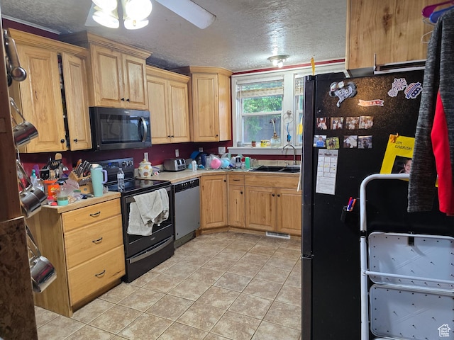 kitchen with black appliances, a sink, a textured ceiling, light tile patterned floors, and a ceiling fan