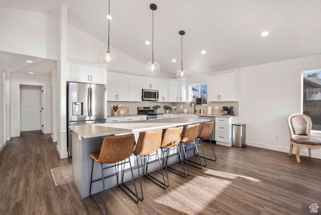 402 W Bluebell Dr, Garden City, UT 84028 - kitchen with appliances with stainless steel finishes, white cabinetry, a center island, dark wood-style floors, and recessed lighting