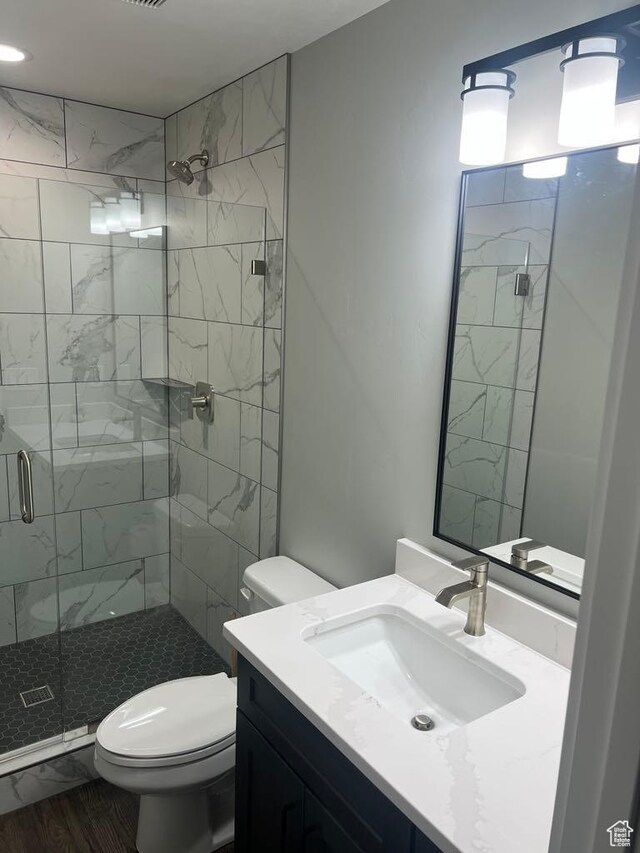 402 W Bluebell Dr, Garden City, UT 84028 - full bathroom featuring toilet, a shower stall, and vanity
