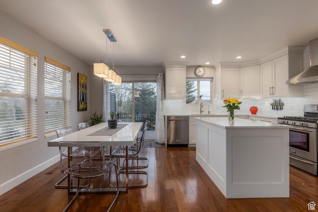 1267 E Foxcrest Ct, Park City, UT 84098 - kitchen featuring appliances with stainless steel finishes, a center island, a sink, light countertops, and decorative backsplash
