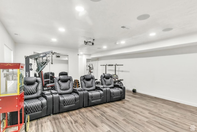 cinema room with light wood-style flooring, recessed lighting, and baseboards