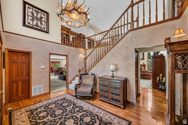 305 S Rachel Ln, New Harmony, UT 84757 - entryway featuring a towering ceiling, wood finished floors, a chandelier, stairway, and baseboards