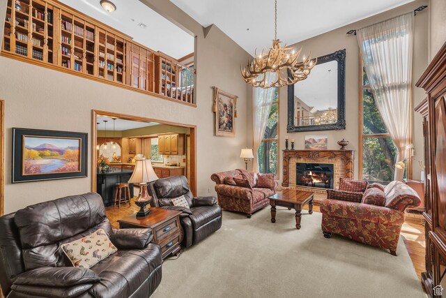305 S Rachel Ln, New Harmony, UT 84757 - carpeted living room with a chandelier, a fireplace, plenty of natural light, and a towering ceiling