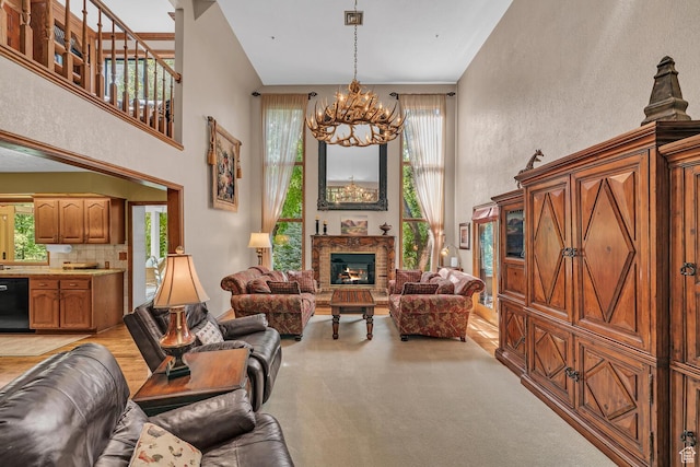 305 S Rachel Ln, New Harmony, UT 84757 - living room with a chandelier, a towering ceiling, light colored carpet, and a warm lit fireplace