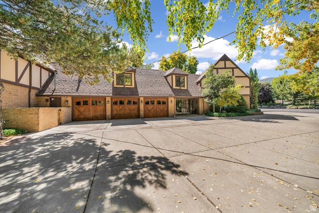 305 S Rachel Ln, New Harmony, UT 84757 - tudor house with driveway, brick siding, and a garage