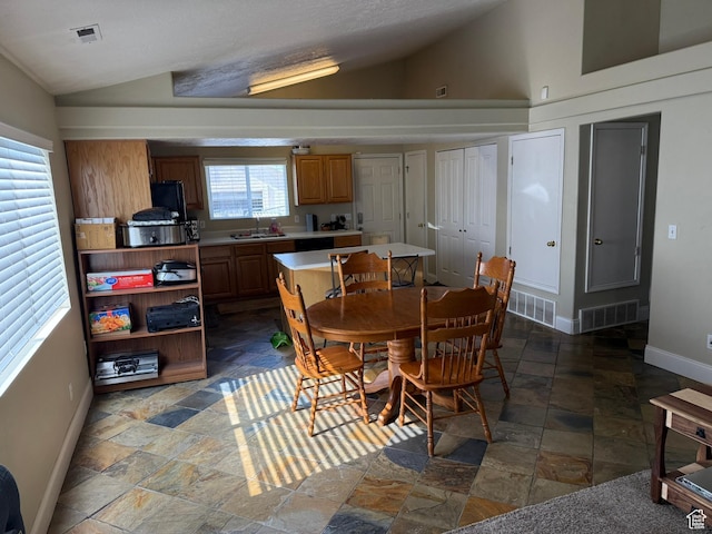 246 W Inauguration Rd S, Draper, UT 84020 - dining area featuring vaulted ceiling, stone tile flooring, and baseboards