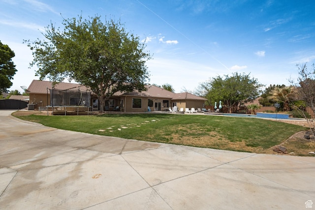 ranch-style house with a trampoline, a swimming pool, a patio area, and a front yard
