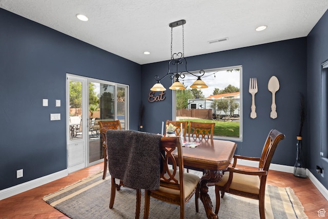 dining area with plenty of natural light, baseboards, light wood finished floors, and recessed lighting