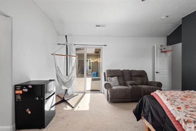 bedroom featuring access to outside, carpet floors, and freestanding refrigerator