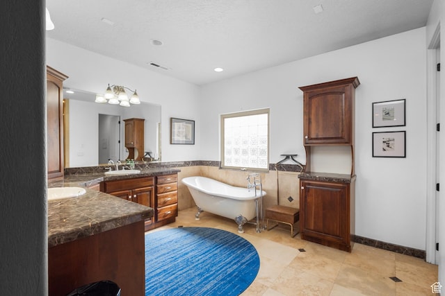 full bathroom featuring vanity, a freestanding bath, wainscoting, recessed lighting, and tile patterned flooring