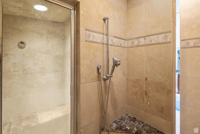 full bath with a shower stall