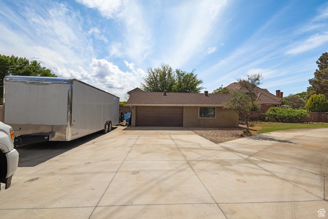 view of front of home featuring concrete driveway and an attached garage