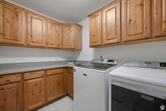 2242 E Deere View Dr N, Layton, UT 84040 - washroom with cabinet space, separate washer and dryer, light tile patterned floors, and a textured ceiling