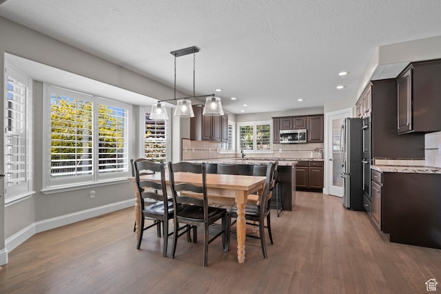 2242 E Deere View Dr N, Layton, UT 84040 - dining space with light wood-style flooring, baseboards, recessed lighting, and a textured ceiling