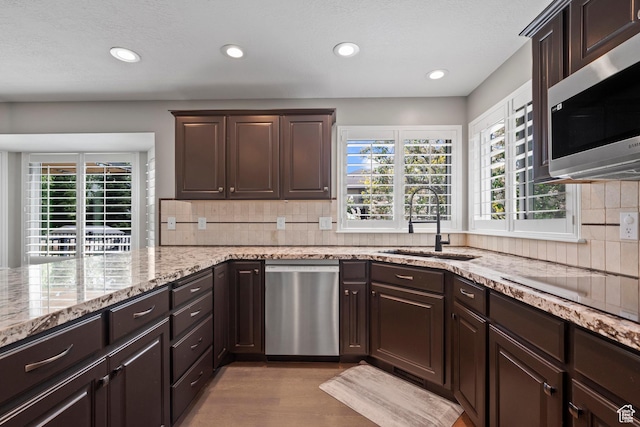 2242 E Deere View Dr N, Layton, UT 84040 - kitchen with appliances with stainless steel finishes, a sink, dark brown cabinetry, and recessed lighting