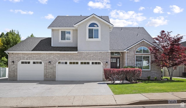 2242 E Deere View Dr N, Layton, UT 84040 - traditional home featuring concrete driveway, a front lawn, a shingled roof, brick siding, and an attached garage