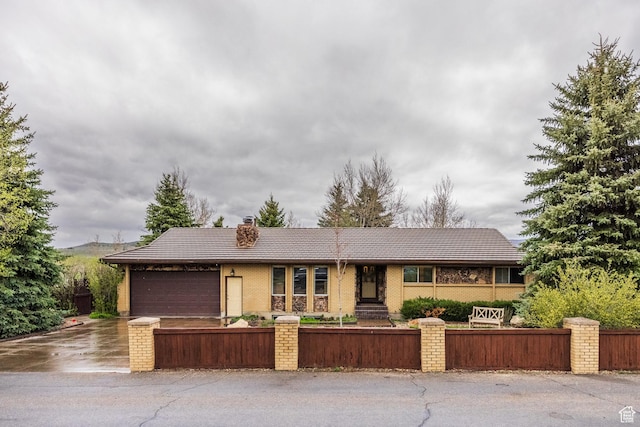 125 E Countryside Cir, Park City, UT 84098 - single story home featuring a fenced front yard, an attached garage, a chimney, and brick siding