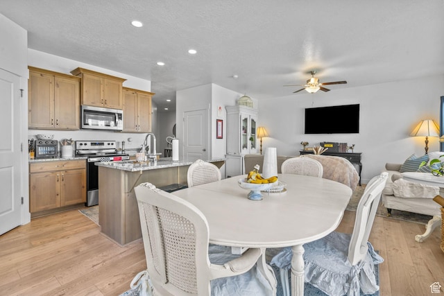 dining room with recessed lighting, a ceiling fan, light wood-style flooring, and a textured ceiling