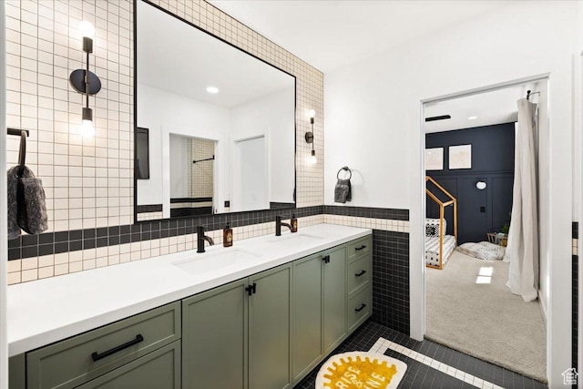 full bath featuring tile walls, tile patterned flooring, and double vanity