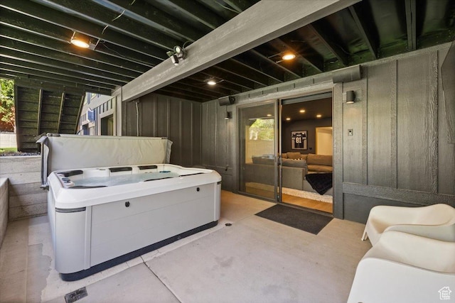 view of patio / terrace with a hot tub and washer / dryer