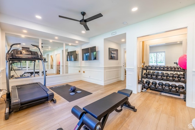 workout area with ceiling fan, wood finished floors, wainscoting, a decorative wall, and recessed lighting