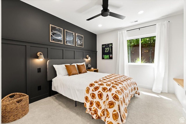 bedroom featuring carpet, recessed lighting, ceiling fan, and a decorative wall